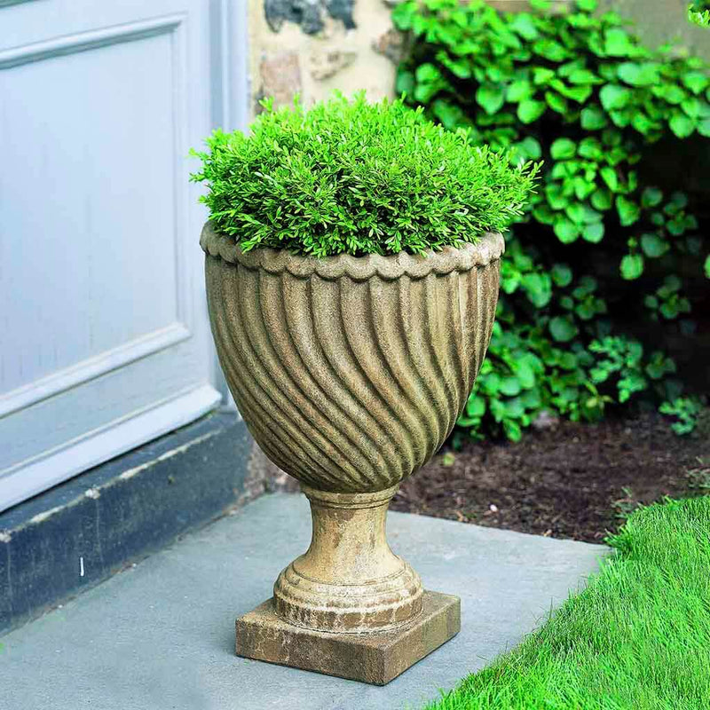 Campania International Ravenna Urn is shown in the Age Limestone Patina. Made from cast stone.