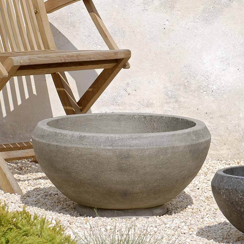 Campania International Giulia Medium Planter is shown in the Greystone Patina. Made from cast stone.