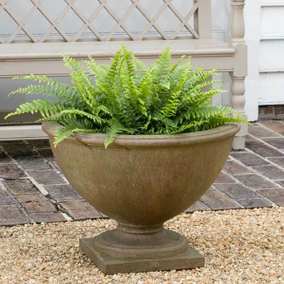 Campania International Williamsburg Basset Hall Urn is shown in the Age Limestone Patina. Made from cast stone.