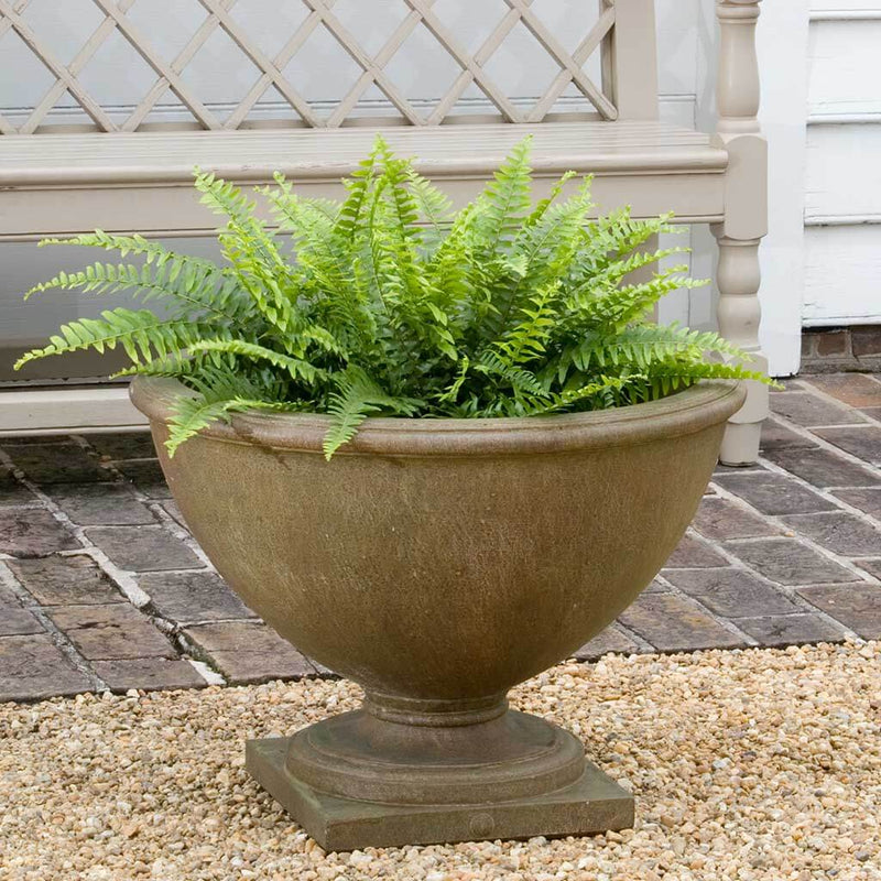  Campania International Williamsburg Basset Hall Urn is shown in the Age Limestone Patina. Made from cast stone.