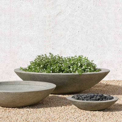 Campania International Low Zen Large Bowl is shown in the Alpine Stone Patina. Made from cast stone.