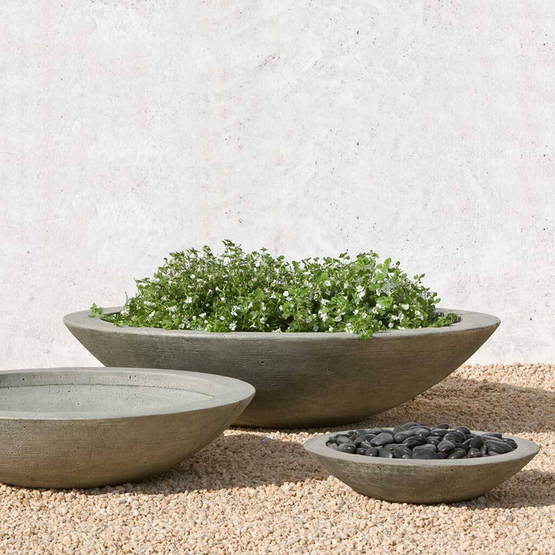 Campania International Low Zen Large Bowl is shown in the Alpine Stone Patina. Made from cast stone.