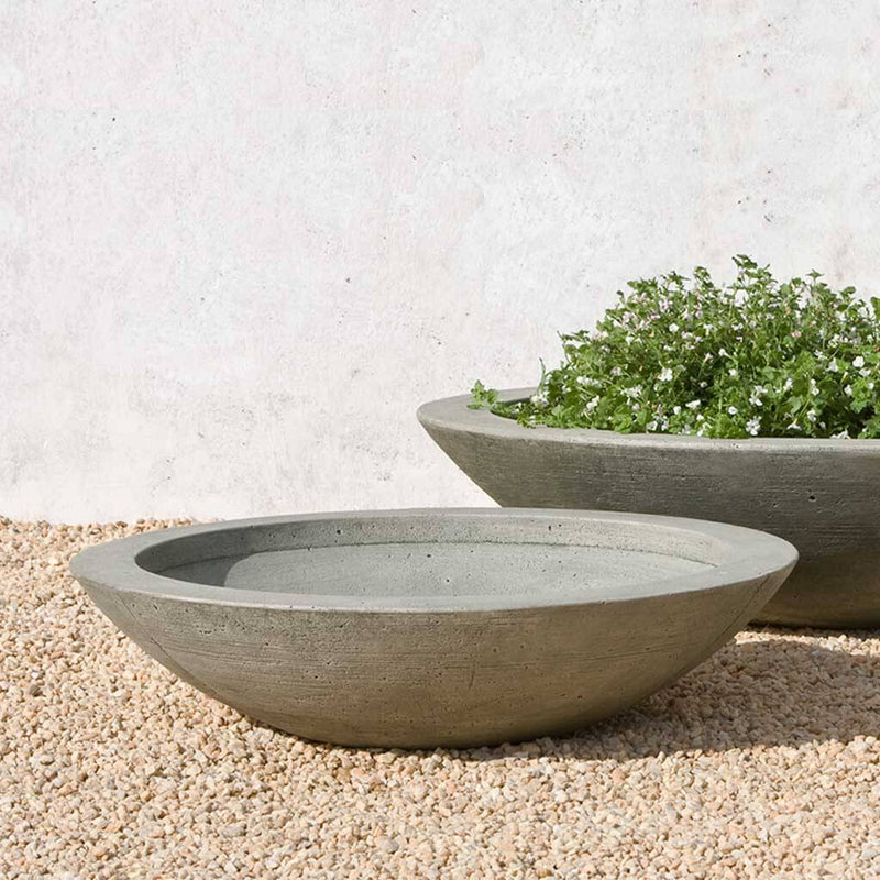 Campania International Low Zen Medium Bowl is shown in the Alpine Stone Patina. Made from cast stone.