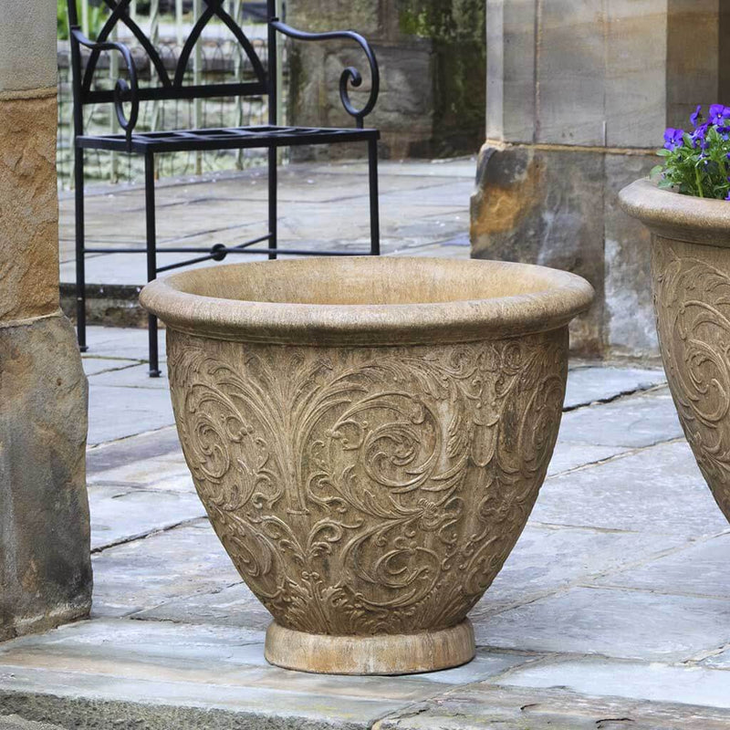 Campania International Arabesque Medium Planter is shown in the Aged Limestone Patina. Made from cast stone.