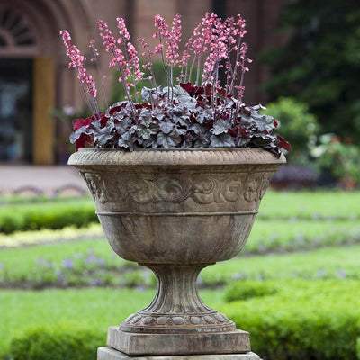 Campania International Smithsonian Foliated Scroll Urn is shown in the Pietra Nuovo Patina. Made from cast stone.