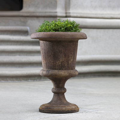 Campania International Smithsonian Goblet Urn is shown in the Pietra Nuovo Patina. Made from cast stone.