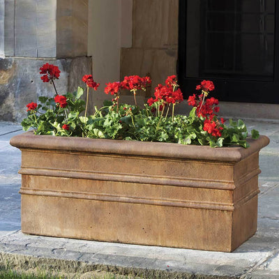 Campania International Classic Rolled Rim Window Box is shown in the Pietra Nuova Patina. Made from cast stone.