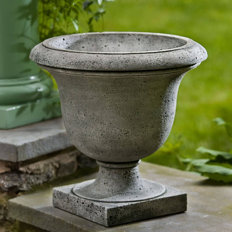 Campania International Litchfield Rustic Urn is shown in the Greystone Patina. Made from cast stone.