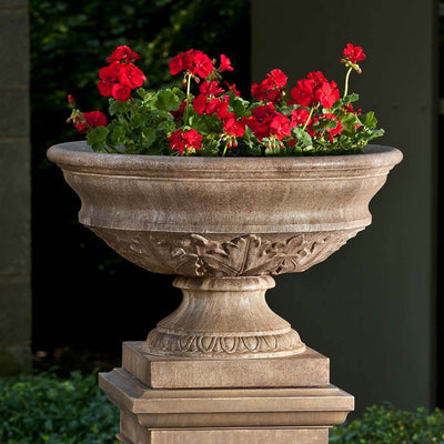 Campania International Coachhouse Urn is shown in the Age Limestone Patina. Made from cast stone.