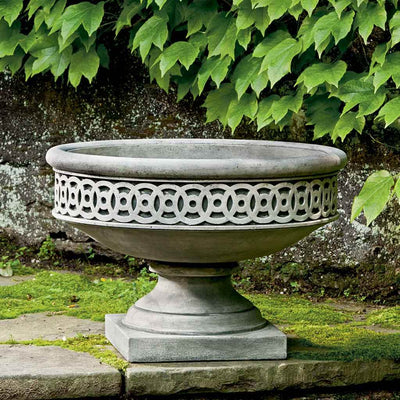 Campania International Williamsburg Low Fretwork Urn is shown in the Alpine Stone Patina. Made from cast stone.