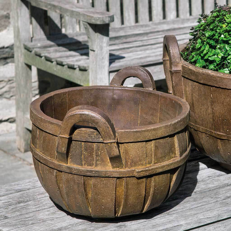 Campania International Apple Basket Small Planter is shown in the Pietra Nuova Patina. Made from cast stone.
