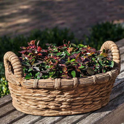Campania International Provencal Basket Planter is shown in the Brownstone Patina. Made from cast stone.