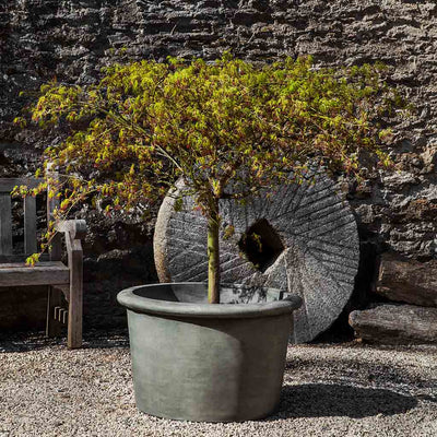 Campania International Palo Alto Low Planter is shown in the Alpine Stone Patina. Made from cast stone.