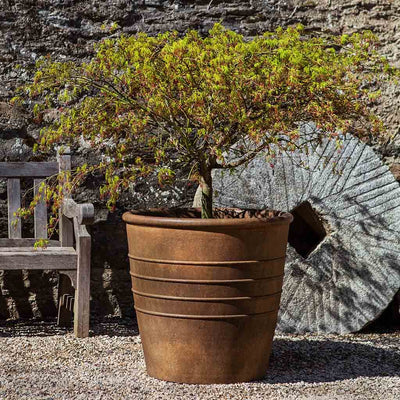 Campania International Mill Valley Planter is shown in the Pietra Nuova Patina. Made from cast stone.