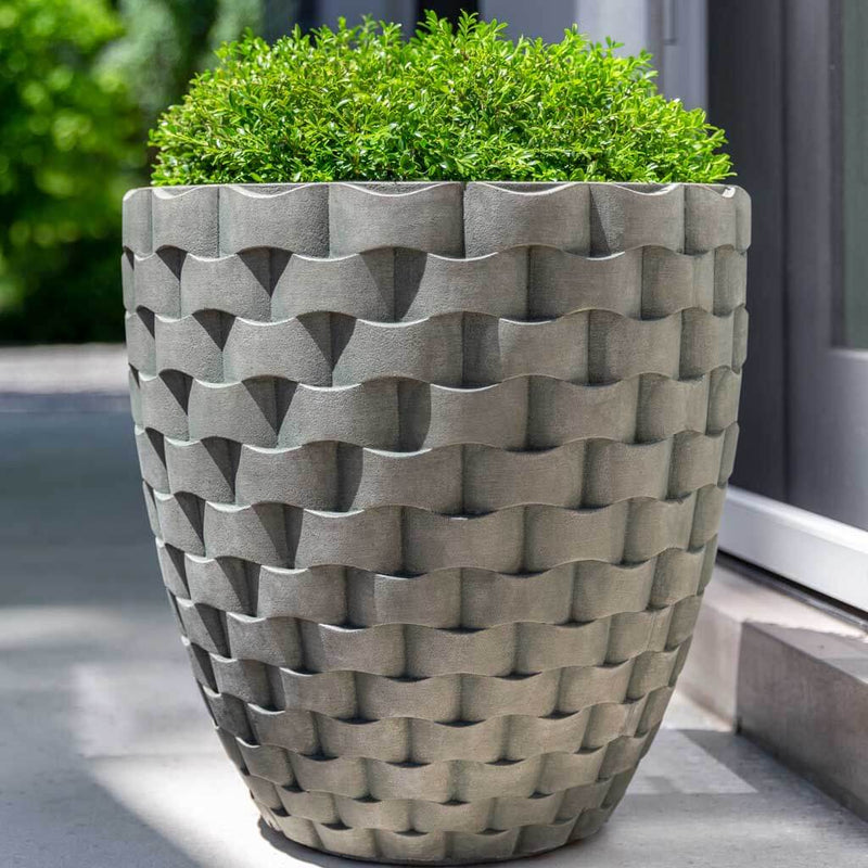 Campania International M Weave Tall Round Planter is shown in the Alpine Stone Patina. Made from cast stone.