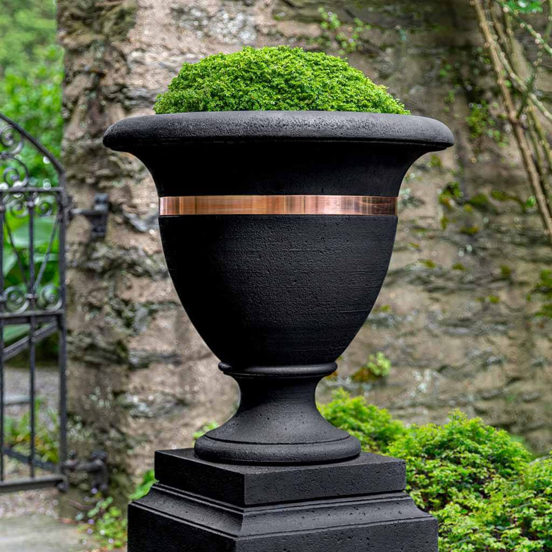 Campania International Classic Copper Banded Large Urn is shown in the Nero Nuovo Patina. Made from cast stone.