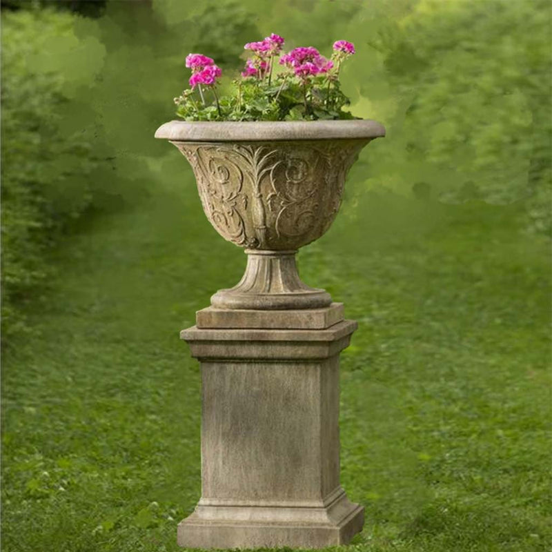 Campania International Palais Arabesque Urn and Pedestal is shown in the Age Limestone Patina. Made from cast stone.