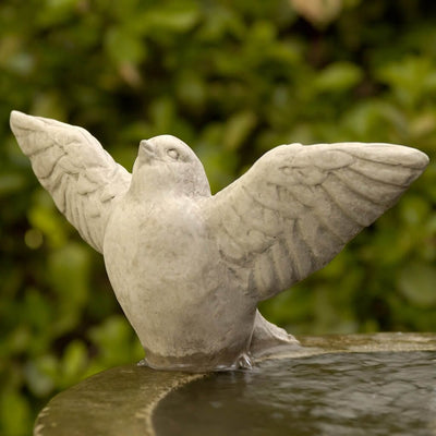 Campania International Flutter Bird Statue , set in the garden to add charm and character. The statue is shown in the Verde Patina.
