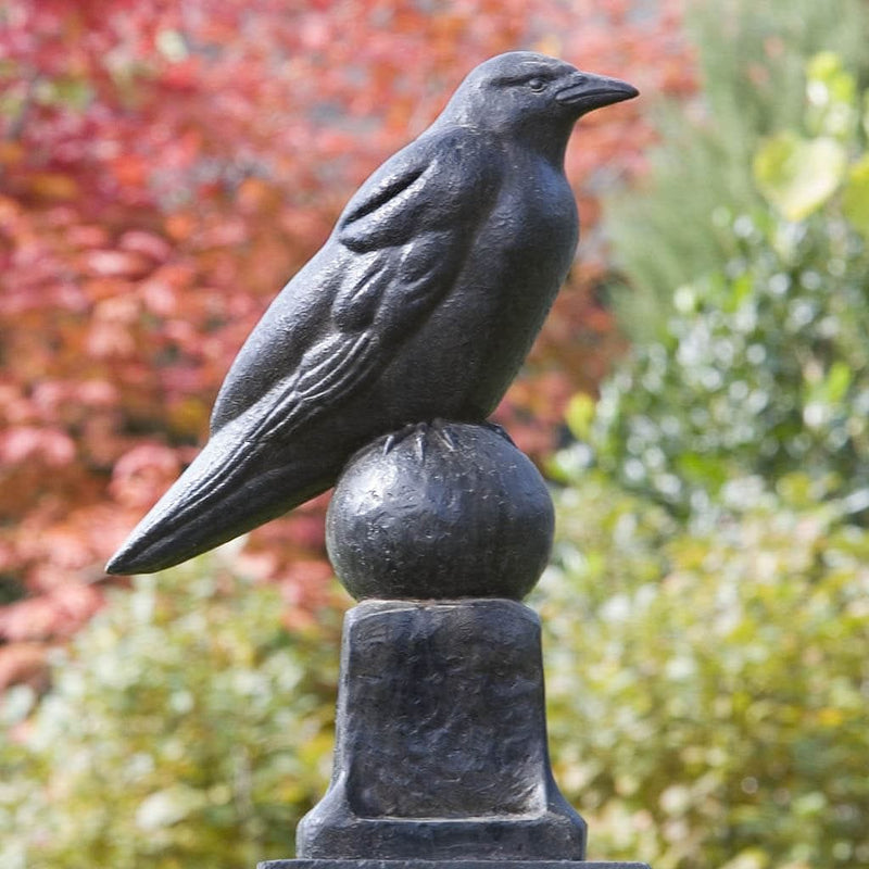 Campania International Raven Statue , set in the garden to add charm and character. The statue is shown in the Nero Nuovo Patina.