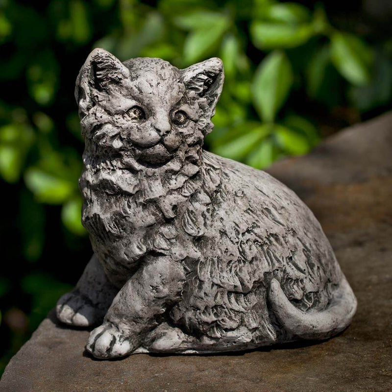 Campania International Cutie Kitty Garden Statue, set in the garden to add charm and character. The statue is shown in the Alpine Stone Patina.
