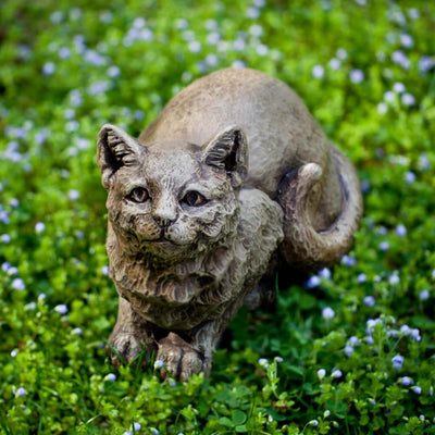 Campania International Patience the Cat Garden Statue, set in the garden to add charm and character. The statue is shown in the Brownstone Patina.