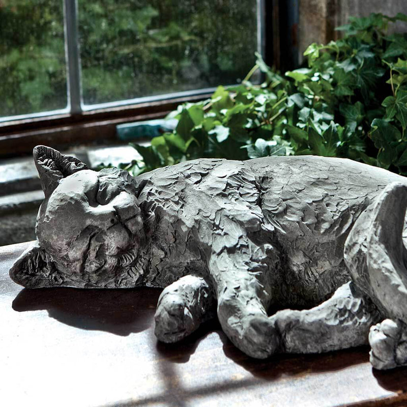 Campania International Dreaming Kitty Garden Statue, set in the garden to add charm and character. The statue is shown in the Alpine Stone Patina.