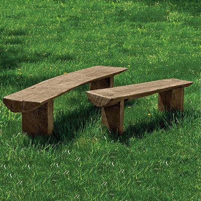 Campania International Large Bois Garden Bench, set in the garden to adding charm and purpose. The bench is shown in the Brownstone Patina.