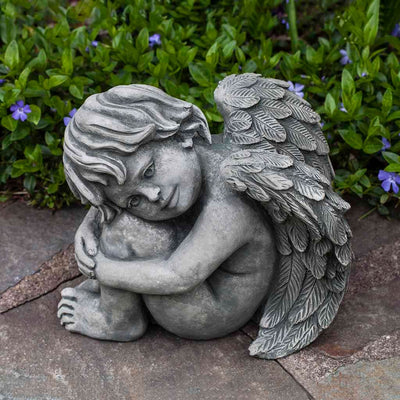 Campania International Evangeline Statue placed in the garden. Religious garden statues, made of cast stone in a range of color options.