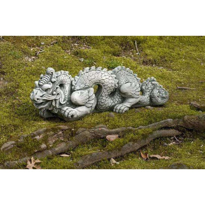 Campania International Dragon Small - Asian Accents Statuary, set in the garden to add charm and character. The statue is shown in the Alpine Stone Patina.