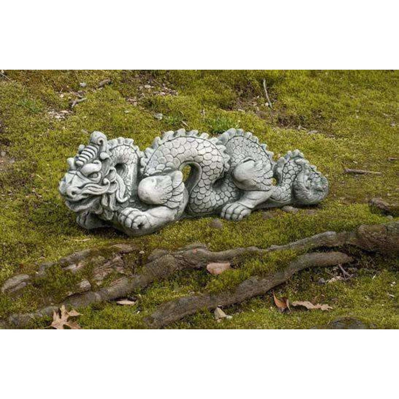 Campania International Dragon Small - Asian Accents Statuary, set in the garden to add charm and character. The statue is shown in the Alpine Stone Patina.
