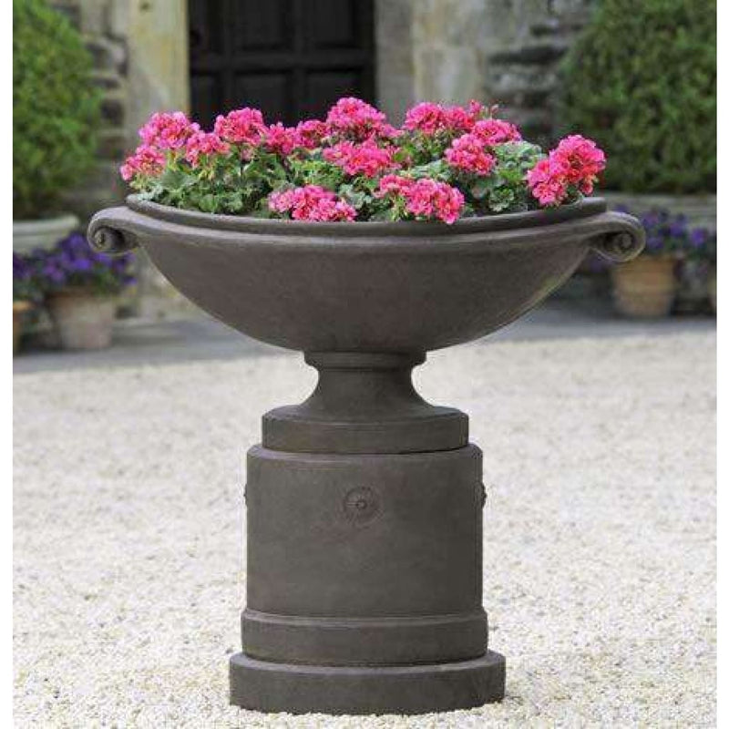 Campania International Medici Pedestal, set in the garden elevate a statue or planter. The pedestal is shown in the Nero Nuovo Patina.