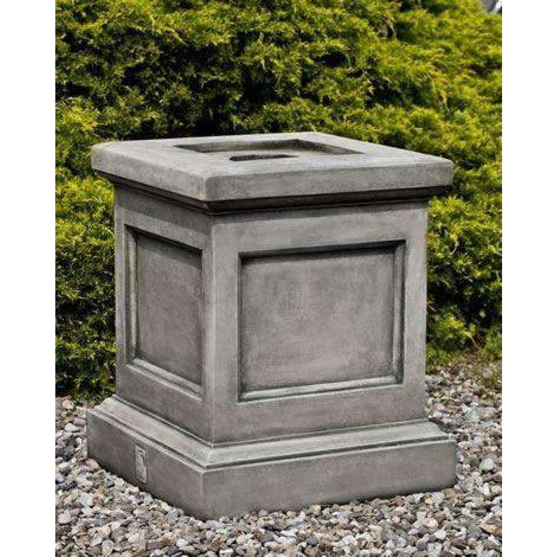 Campania International St. Louis Pedestal, set in the garden elevate a statue or planter. The pedestal is shown in the Alpine Stone Patina.