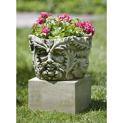 Campania International Textured Small Low Square Pedestal, set in the garden elevate a statue or planter. The pedestal is shown in the Verde Patina.