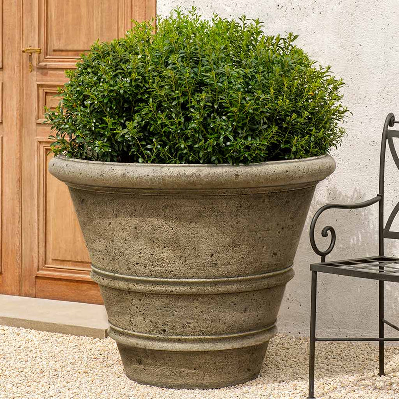 Campania International Rustic Rolled Rim 40 inch a big planter that makes a timeless statement, shown in the Alpine Stone Patina. Made from cast stone.