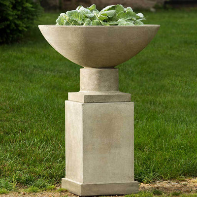 Campania International Savoy Planter with Pedestal is shown in the Verde Patina. Made from cast stone.