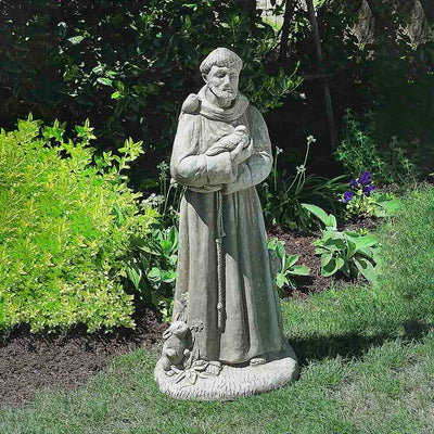 Campania International 36 inch St. Francis with Animals Statue placed in the garden. Religious garden statues, made of cast stone in a range of color options.