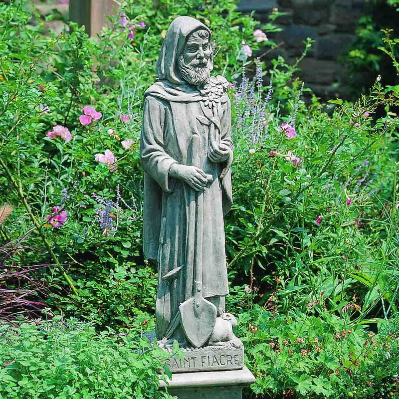 Campania International Saint Fiacre Statue placed in the garden. Religious garden statues, made of cast stone in a range of color options.
