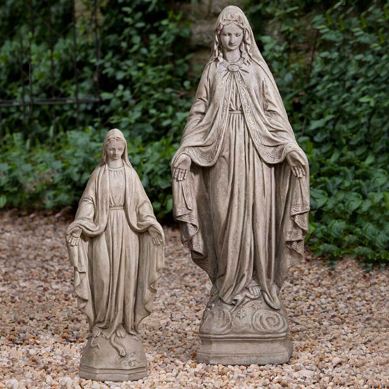 Campania International Medium Madonna Statue placed in the garden. Religious garden statues, made of cast stone in a range of color options.