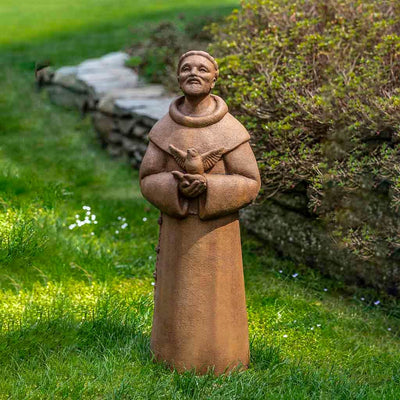 Campania International Contemporary St. Francis Statue placed in the garden. Religious garden statues, made of cast stone in a range of color options.