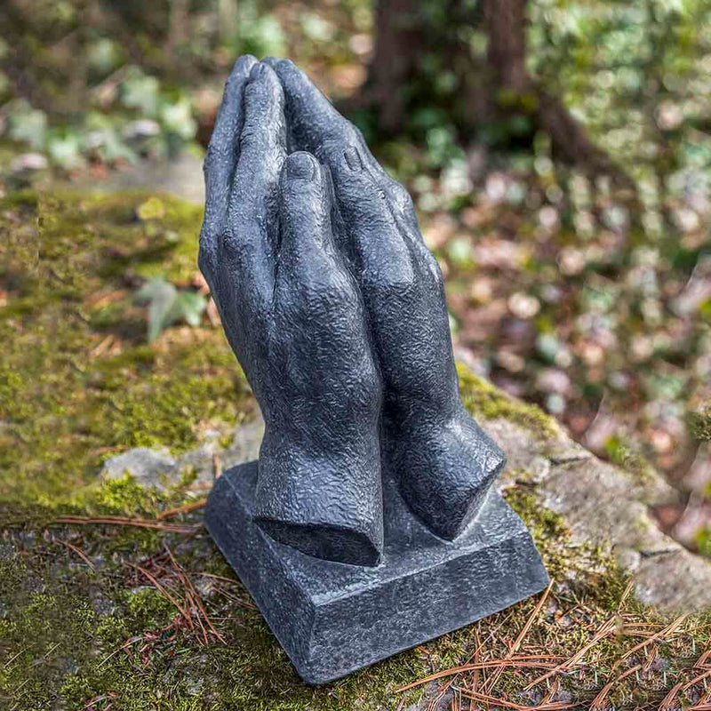 Campania International Prayer Statue placed in the garden. Religious garden statues, made of cast stone in a range of color options.
