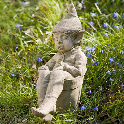 Campania International Joe Statue, set in the garden to add charm and character. The statue is shown in the English Moss Patina.