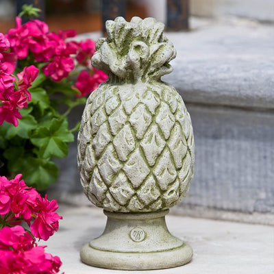 Campania International Williamsburg Pineapple Finial Statue stained in the English Moss patina, the ideal color for this garden statue.