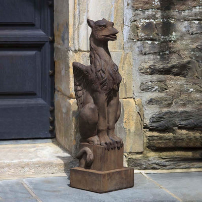 Campania International Gryphon Statue, set in the garden to add charm and character. The statue is shown in the Pietra Nuova Patina.