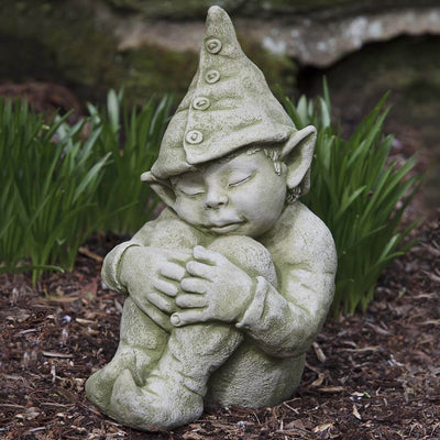 Campania International Galen Statue, set in the garden to add charm and character. The statue is shown in the English Moss Patina.