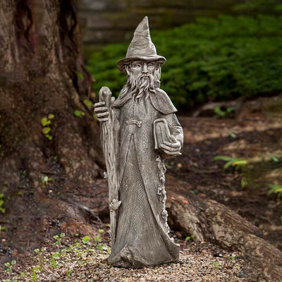 Campania International Merlin Statue, set in the garden to add charm and character. The statue is shown in the Alpine Stone Patina.
