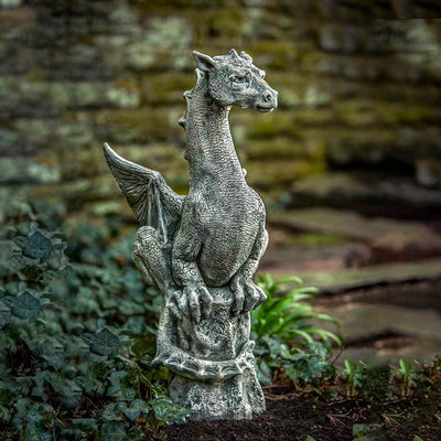 Campania International Abraxas Statue, set in the garden to add charm and character. The statue is shown in the Alpine Stone Patina.