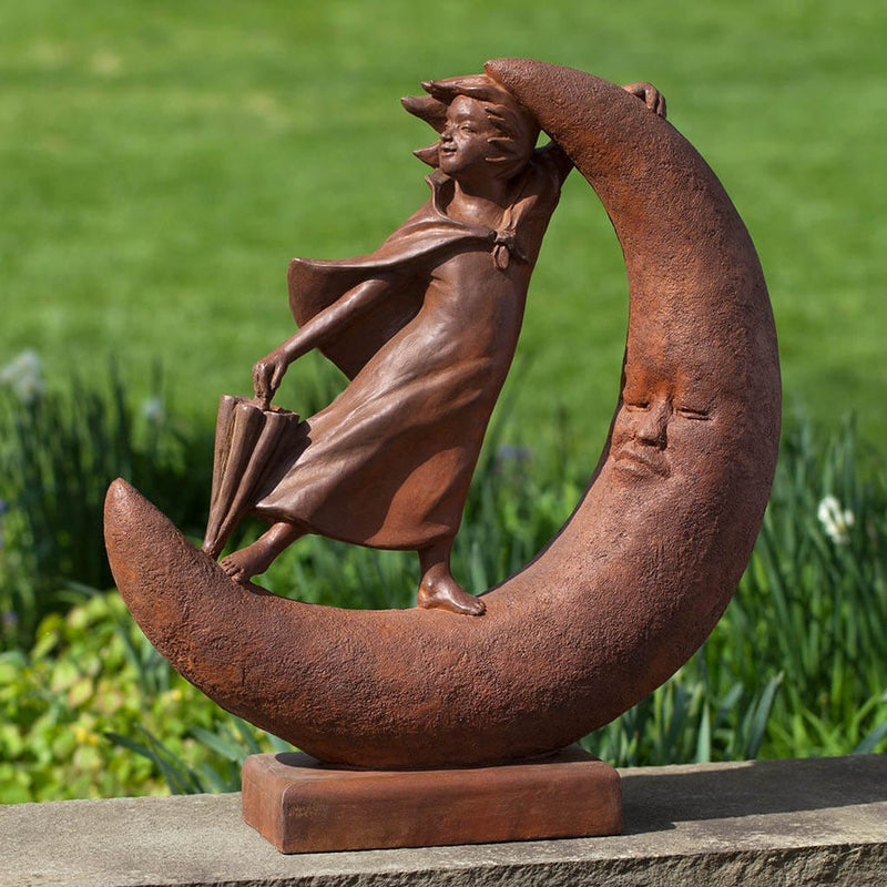 Campania International Once Upon a Moon Statue, set in the garden to add charm and character. The statue is shown in the Ferro Rustico Nuovo Patina.