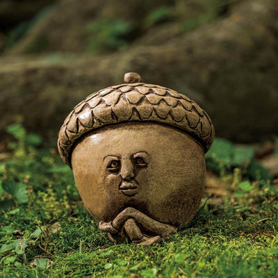 Campania International Cornie Statue, set in the garden to add charm and character. The statue is shown in the Brownstone Patina.